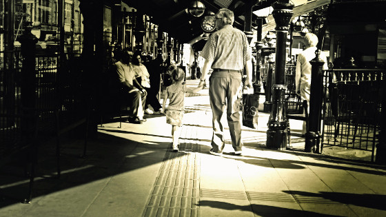 A grandfrather walking with a grandchild